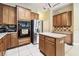 Modern kitchen with stainless steel appliances, tile floors, and custom cabinetry at 7246 Bucks Ford Dr, Riverview, FL 33578