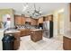 Kitchen with stainless steel appliances, custom cabinets, tile backsplash and floors at 7246 Bucks Ford Dr, Riverview, FL 33578