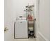 Functional laundry room with washer, dryer and shelving for storage at 7246 Bucks Ford Dr, Riverview, FL 33578
