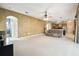 Spacious living room with an archway to the bathroom and kitchen, and a ceiling fan at 7246 Bucks Ford Dr, Riverview, FL 33578