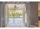 View of a cozy screened-in porch that overlooks a beautiful lake and lush landscaping at 7246 Bucks Ford Dr, Riverview, FL 33578