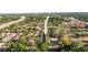 A scenic aerial view shows the property nestled in a vibrant community with lush greenery and convenient access to the highway at 7703 N Branch Ave, Tampa, FL 33604