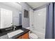 Bathroom featuring a vanity with granite countertop and a shower and bath tub combo at 7703 N Branch Ave, Tampa, FL 33604