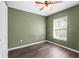 Bedroom with natural light, ceiling fan and wood floor at 7703 N Branch Ave, Tampa, FL 33604