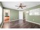 Bedroom with ceiling fan, laminate floors and view of a vanity area at 7703 N Branch Ave, Tampa, FL 33604