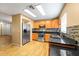 Modern kitchen featuring wood cabinets, granite countertops and stainless steel appliances at 7703 N Branch Ave, Tampa, FL 33604