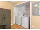 Functional laundry area includes a washer, dryer, utility closet and Liberty Safe for storing valuables at 7703 N Branch Ave, Tampa, FL 33604