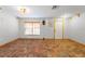 Empty living room offering a large window and unique hexagonal tile flooring at 7703 N Branch Ave, Tampa, FL 33604