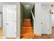 Stairway featuring wood stairs between two white doors at 7703 N Branch Ave, Tampa, FL 33604