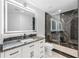 Sleek bathroom with modern vanity, LED mirror, and glass-enclosed shower with black marble tile at 777 N Ashley Dr # 1506, Tampa, FL 33602