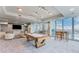 Bright game room featuring a pool table, comfortable seating, and floor-to-ceiling windows with beautiful city views at 777 N Ashley Dr # 1506, Tampa, FL 33602