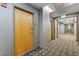 Condo hallway with an exit sign and carpet with geometric pattern leading to apartments at 777 N Ashley Dr # 1506, Tampa, FL 33602
