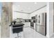 Modern kitchen with stainless steel appliances, black countertops, and a stylish breakfast bar at 777 N Ashley Dr # 1506, Tampa, FL 33602