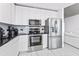 Contemporary kitchen featuring stainless steel appliances, white cabinets, and a marble backsplash at 777 N Ashley Dr # 1506, Tampa, FL 33602