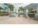Resort-style pool deck with comfortable lounge seating, shaded pergola, and lush landscaping with beautiful city view at 777 N Ashley Dr # 1506, Tampa, FL 33602