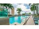 Sparkling pool with clear blue water and ladder, surrounded by palm trees and lounge chairs on a sunny day at 777 N Ashley Dr # 1506, Tampa, FL 33602