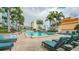 Inviting swimming pool surrounded by comfortable lounge chairs, palm trees, and urban scenery at 777 N Ashley Dr # 1506, Tampa, FL 33602