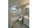 A full bathroom with a tub, sink, toilet, tile surround and a shower head at 7831 Fox Hollow Dr, Port Richey, FL 34668