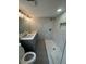 A full bathroom with a double sink vanity, a stand up shower with marble tile surround, and a low flow toilet at 7831 Fox Hollow Dr, Port Richey, FL 34668