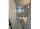 Nicely updated bathroom with marble tile walk-in shower, white vanity and modern fixtures at 7831 Fox Hollow Dr, Port Richey, FL 34668
