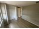 Cozy bedroom with neutral colors, wood floors, and a closet at 7831 Fox Hollow Dr, Port Richey, FL 34668