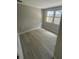 Neutral cozy bedroom with wood floors and a big window providing plenty of natural light at 7831 Fox Hollow Dr, Port Richey, FL 34668