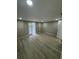 Well-lit bedroom with plank floors features access to the backyard at 7831 Fox Hollow Dr, Port Richey, FL 34668