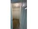 Walk-in closet with hanging shelf and wood floors at 7831 Fox Hollow Dr, Port Richey, FL 34668
