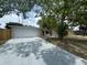Charming one-story home featuring an attached garage and spacious front yard at 7831 Fox Hollow Dr, Port Richey, FL 34668
