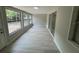 Light-filled sunroom with neutral colors, a lot of windows and a sliding glass door at 7831 Fox Hollow Dr, Port Richey, FL 34668