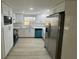 Modern kitchen with stainless steel appliances, white cabinets, and sleek countertops at 7831 Fox Hollow Dr, Port Richey, FL 34668