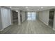 Spacious living room with modern flooring, fresh paint, and great natural light at 7831 Fox Hollow Dr, Port Richey, FL 34668