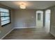 Bright living room with wood floors, a view to the dining room and decorative light fixture at 7831 Fox Hollow Dr, Port Richey, FL 34668