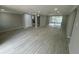 Open living room featuring modern floors and great natural light from sliding glass door at 7831 Fox Hollow Dr, Port Richey, FL 34668