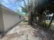 A bare yard with sparse grass and large trees at 7831 Fox Hollow Dr, Port Richey, FL 34668
