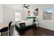 Inviting bedroom featuring hardwood floors and ample natural light at 7911 N Packwood Ave, Tampa, FL 33604
