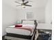 Sunlit bedroom with a comfortable bed and a work desk and chair at 7911 N Packwood Ave, Tampa, FL 33604