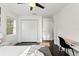 Bright bedroom with dark hardwood floors, a ceiling fan, and a closet with bi-fold doors at 7911 N Packwood Ave, Tampa, FL 33604
