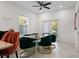 Elegant dining area with unique chairs and plenty of natural light from the window at 7911 N Packwood Ave, Tampa, FL 33604