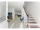 Inviting foyer with a view to the living area and staircase with wood treads at 7911 N Packwood Ave, Tampa, FL 33604