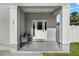 Inviting front porch with chairs and a 'Welcome' sign next to the front door at 7911 N Packwood Ave, Tampa, FL 33604