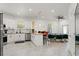 Bright and spacious kitchen with granite countertops and a seamless transition to the dining area at 7911 N Packwood Ave, Tampa, FL 33604