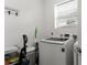 Functional laundry room featuring a modern washer and dryer with a white bench at 7911 N Packwood Ave, Tampa, FL 33604