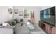 Comfortable living room featuring a modern couch, stylish decor, and natural light at 7911 N Packwood Ave, Tampa, FL 33604