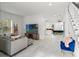Bright living room with tile flooring and staircase leading to upper level at 7911 N Packwood Ave, Tampa, FL 33604