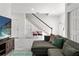 Open-concept living area with neutral decor and a staircase leading to the second floor at 7911 N Packwood Ave, Tampa, FL 33604
