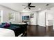 Bright main bedroom offering dark floors, a cozy sofa, and modern decor at 7911 N Packwood Ave, Tampa, FL 33604
