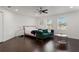 Spacious main bedroom featuring dark wood floors, a sitting area, and ample natural light at 7911 N Packwood Ave, Tampa, FL 33604