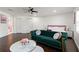 Stylish main bedroom boasting dark floors, a cozy sofa, and modern decor at 7911 N Packwood Ave, Tampa, FL 33604