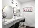 Stylish makeup station featuring mirrors, a long white counter and black chairs at 7911 N Packwood Ave, Tampa, FL 33604
